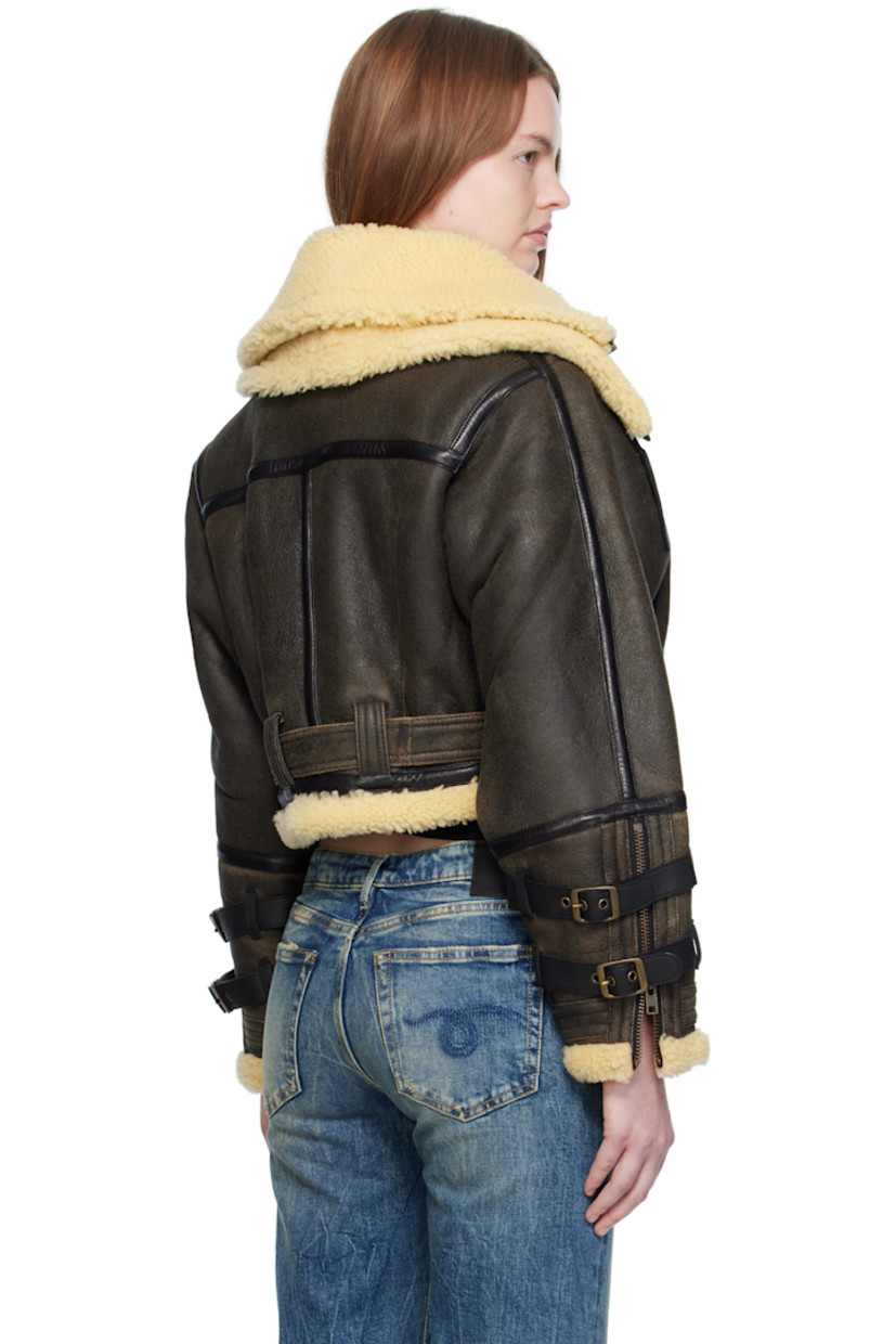 Dyed shearling jacket. 

· Layered funnel necks
· Pin-buckle straps at collar and cuffs
· Zip closure
· Zip pockets at waist
· Cropped hem
· Belt loops and detachable pin-buckle belt at hem
· Zip vent at cuffs

Supplier color: Black with cream