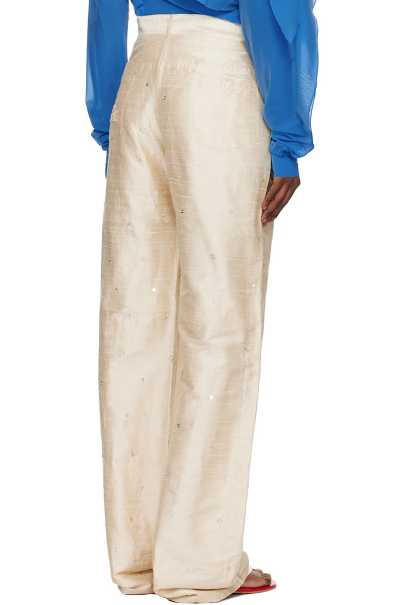 Handcrafted silk faille trousers.

· Sequins and beading throughout
· Belt loops
· Four-pocket styling
· Zip fly
· Logo graphic embroidered and beaded at front
· Crystal-cut logo at back pocket

Supplier color: White