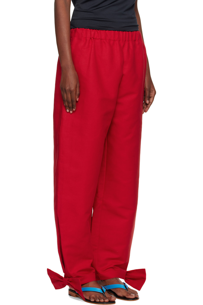 Linen canvas trousers.

· Elasticized waistband
· Two-pocket styling
· Curved outseams
· Detachable bow and press-stud fastening at cuffs

Supplier color: Red