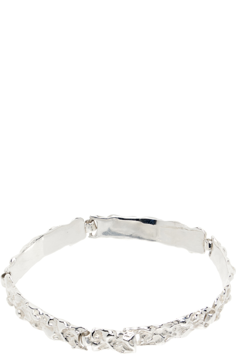 Handcrafted textured cuff bracelet in sterling silver. Logo-engraved hook-eye fastening.

Supplier color: Sterling silver
