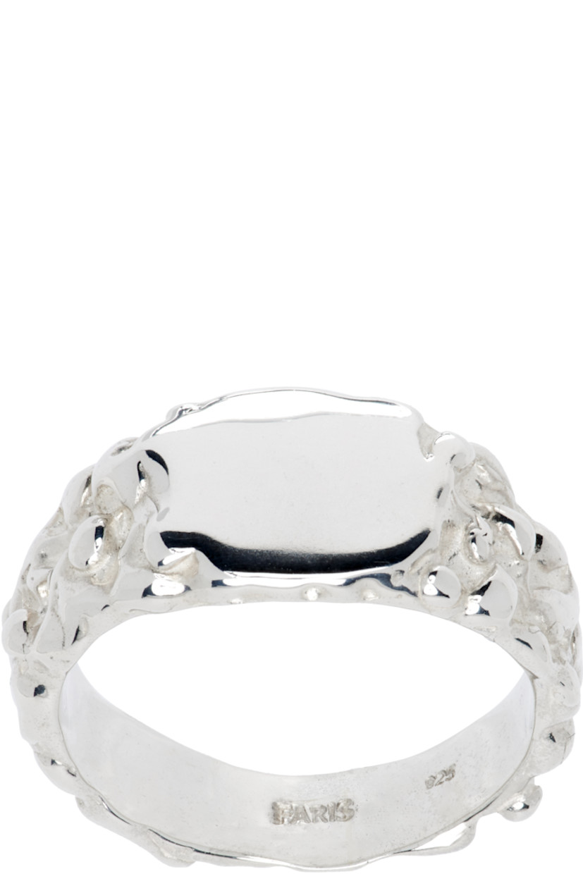 Handcrafted textured signet ring in sterling silver. Logo engraved at inner band.

Supplier color: Sterling silver
