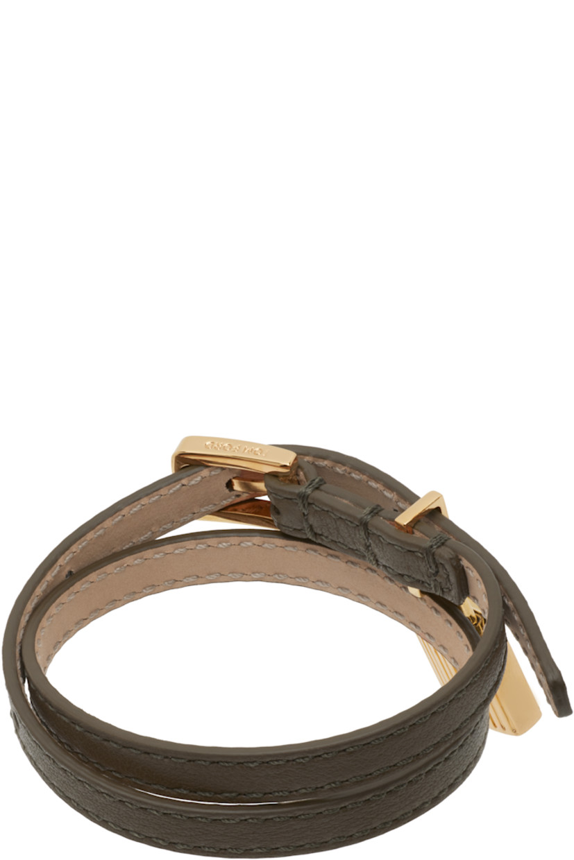 Wraparound grained calfskin bracelet in khaki.

· Fluted padlock charm at face
· Logo-engraved pin-buckle fastening 
· Gold-tone hardware
· L15.5"

Supplier color: Dark olive