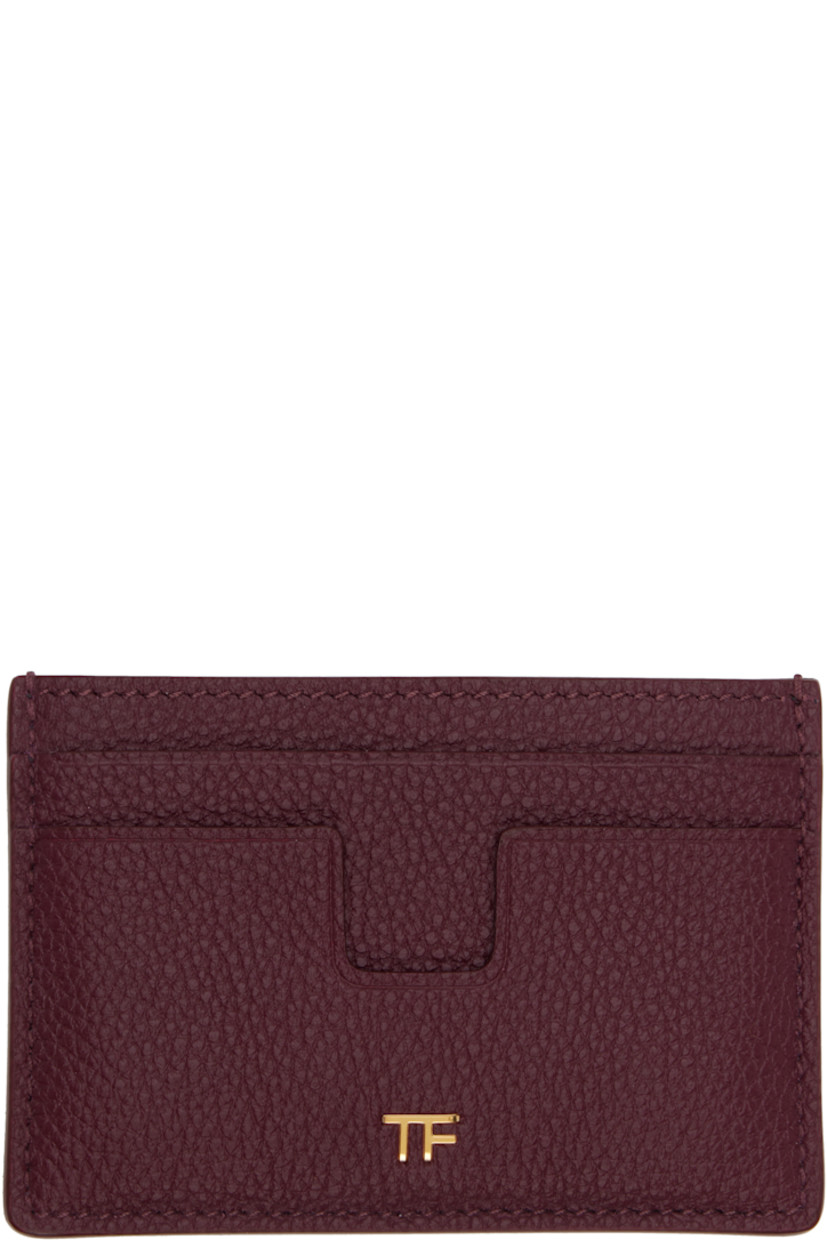 Pebble-grained calfskin card holder. 

�· Inset logo hardware at face
· Four card slots and central note slot 
· Sheepskin lining 
· Gold-tone hardware
· H2.75" x W4" 

Supplier color: Red plum