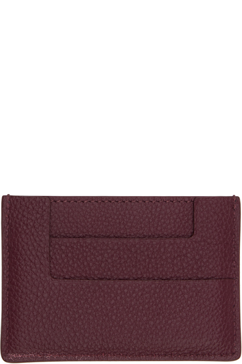Pebble-grained calfskin card holder. 

· Inset logo hardware at face
· Four card slots and central note slot 
· Sheepskin lining 
· Gold-tone hardware
· H2.75" x W4" 

Supplier color: Red plum