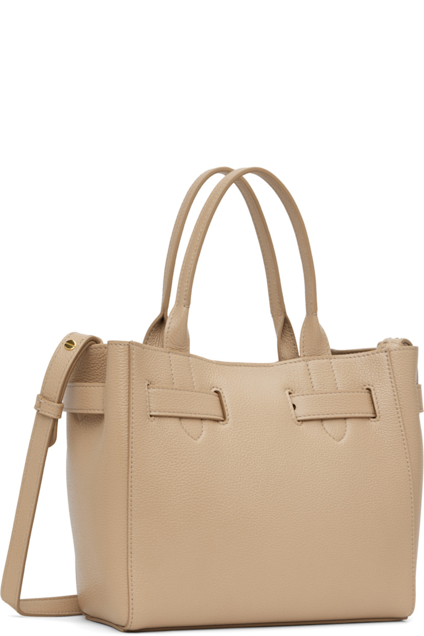 Grained calfskin top handle bag.

· Twin carry handles
· Adjustable and detachable crossbody strap
· Logo hardware at adjustable post-stud strap
· Logo stamp at face
· Magnetic tab fastening at throat
· Patch pocket at interior
· Leather interior
· H8" x W9" x D4" 

Supplier color: Light beige