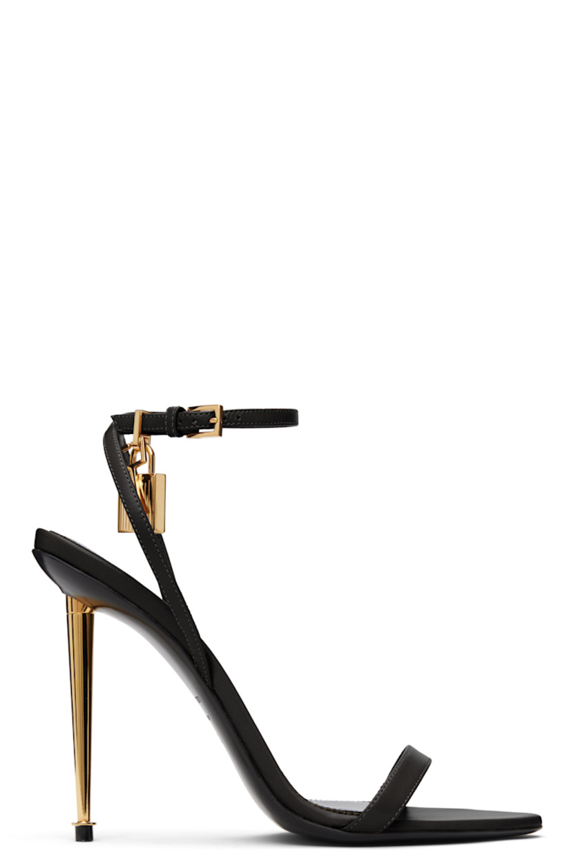 Buffed goatskin heeled sandals.

· Open pointed toe
· Padlock and logo charm at pin-buckle ankle strap
· Logo printed at leather footbed
· Metal stiletto heel with rubber injection
· Polished leather sole
· Logo-engraved gold-tone hardware
· Heel: H4.25"

Supplier color: Black