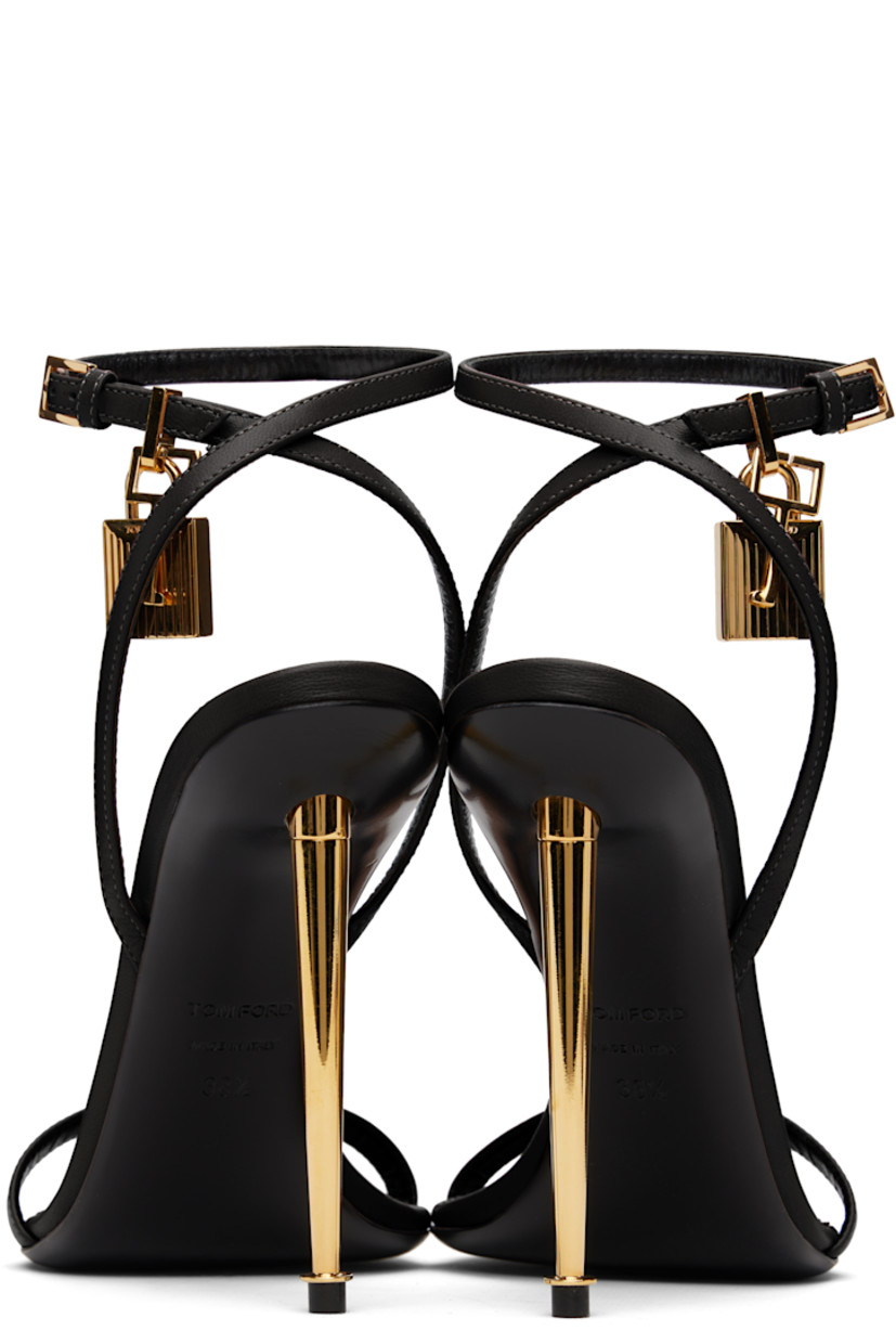 Buffed goatskin heeled sandals.

· Open pointed toe
· Padlock and logo charm at pin-buckle ankle strap
· Logo printed at leather footbed
· Metal stiletto heel with rubber injection
· Polished leather sole
· Logo-engraved gold-tone hardware
· Heel: H4.25"

Supplier color: Black