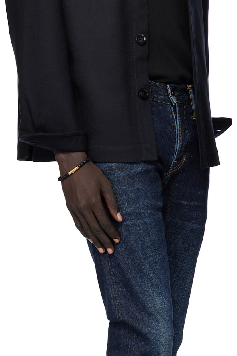 Braided grained calfskin bracelet.

· Logo-engraved press-stud closure
· Gold-tone brass hardware

Supplier color: Black