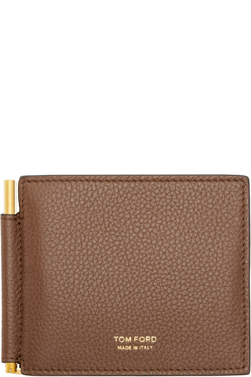 Grained leather bifold wallet.

· Logo stamp at face
· Eight card slots 
· Logo-engraved money clip at interior
· Leather interior
· Textile lining
· H3.5" x W4.5"

Supplier color: Mid brown