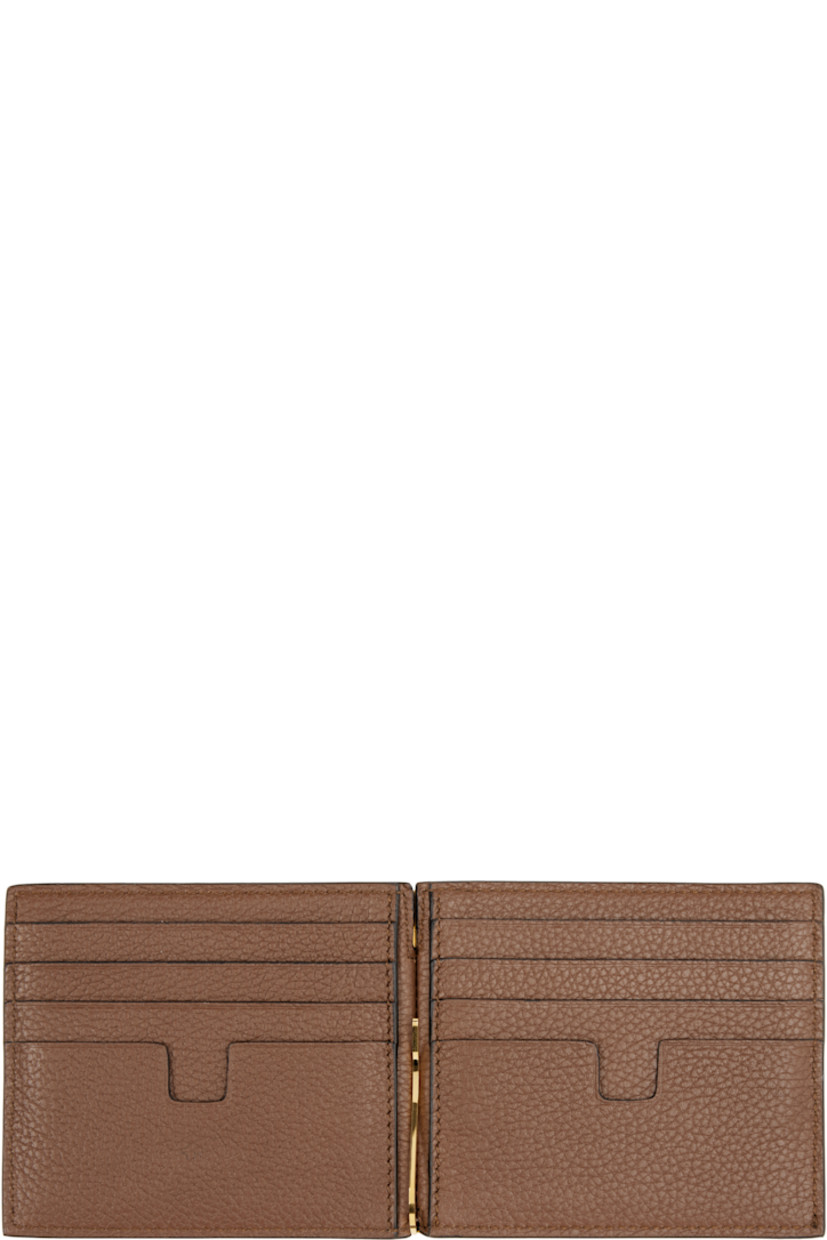 Grained leather bifold wallet.

· Logo stamp at face
· Eight card slots 
· Logo-engraved money clip at interior
· Leather interior
· Textile lining
· H3.5" x W4.5"

Supplier color: Mid brown