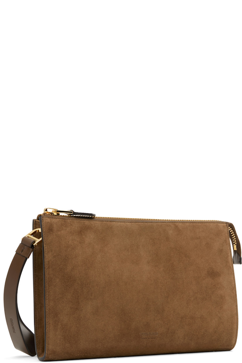 Calfskin suede pouch.

· Logo-embossed wristlet at top
· Gold-tone logo stamp at face
· Zip closure
· Patch pocket at interior 
· Cotton-blend twill lining
· Gold-tone hardware
· H7" x W10.25" x D1"

Supplier color: Walnut