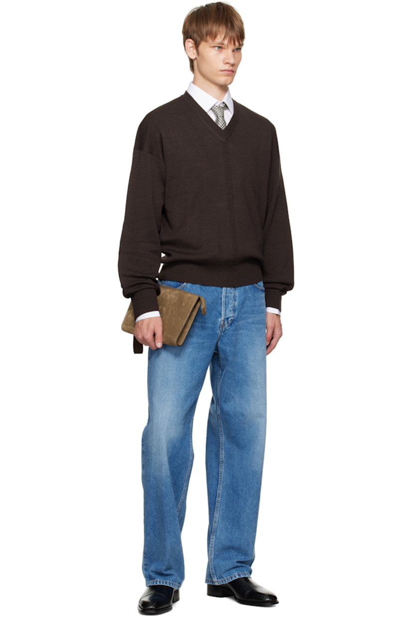 Calfskin suede pouch.

· Logo-embossed wristlet at top
· Gold-tone logo stamp at face
· Zip closure
· Patch pocket at interior 
· Cotton-blend twill lining
· Gold-tone hardware
· H7" x W10.25" x D1"

Supplier color: Walnut