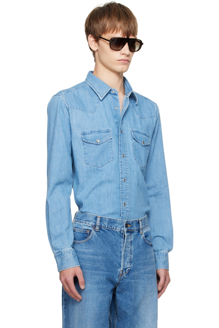 Non-stretch denim shirt.

· Fading throughout
· Spread collar
· Press-stud closure
· Western yoke at front and back
· Flap pockets at chest
· Shirttail hem
· Press-stud barrel cuffs

Supplier color: Washed blue