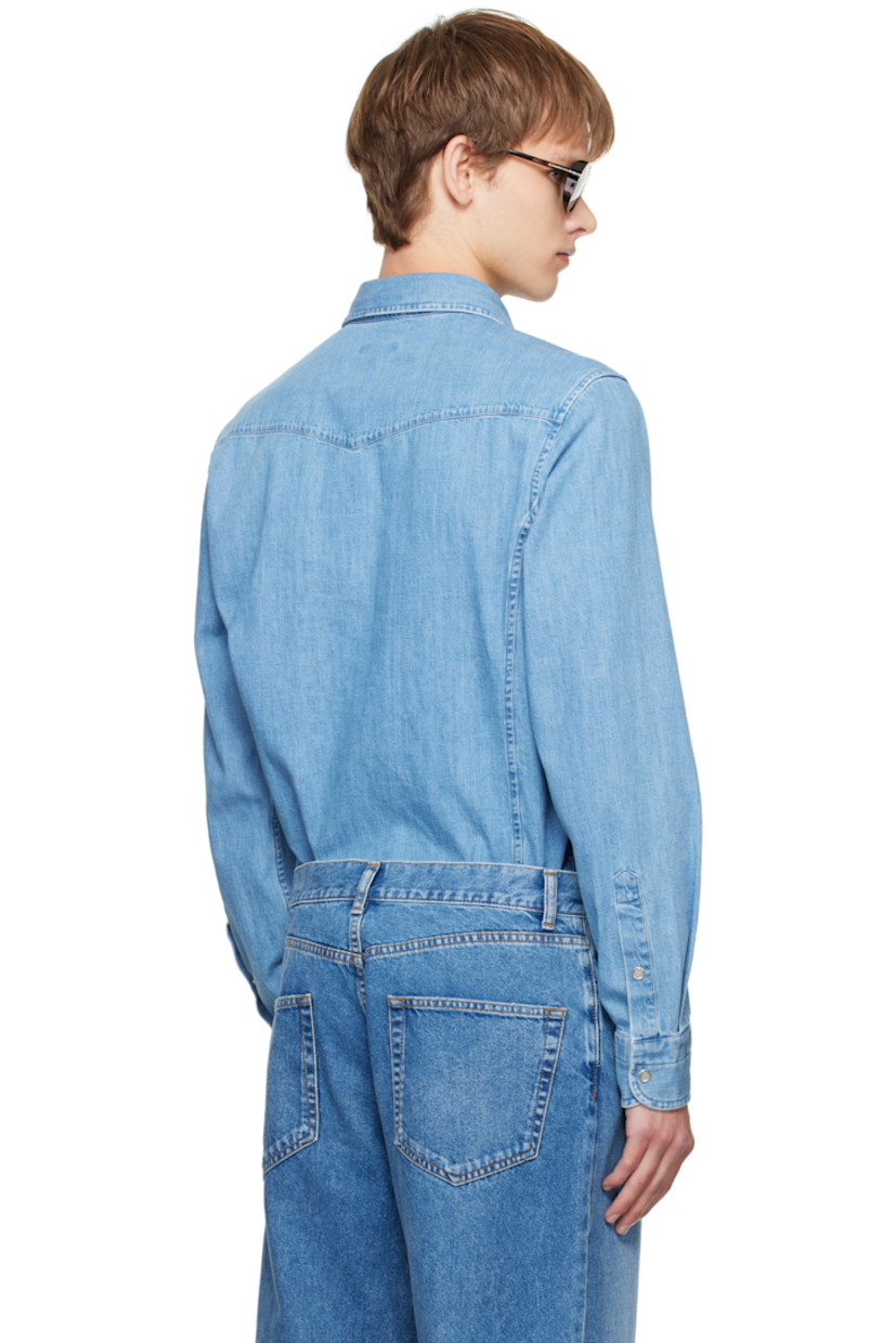 Non-stretch denim shirt.

· Fading throughout
· Spread collar
· Press-stud closure
· Western yoke at front and back
· Flap pockets at chest
· Shirttail hem
· Press-stud barrel cuffs

Supplier color: Washed blue