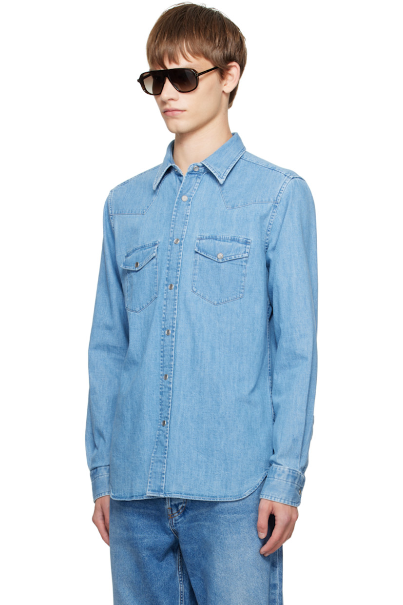 Non-stretch denim shirt.

· Fading throughout
· Spread collar
· Press-stud closure
· Western yoke at front and back
· Flap pockets at chest
· Shirttail hem
· Press-stud barrel cuffs

Supplier color: Washed blue