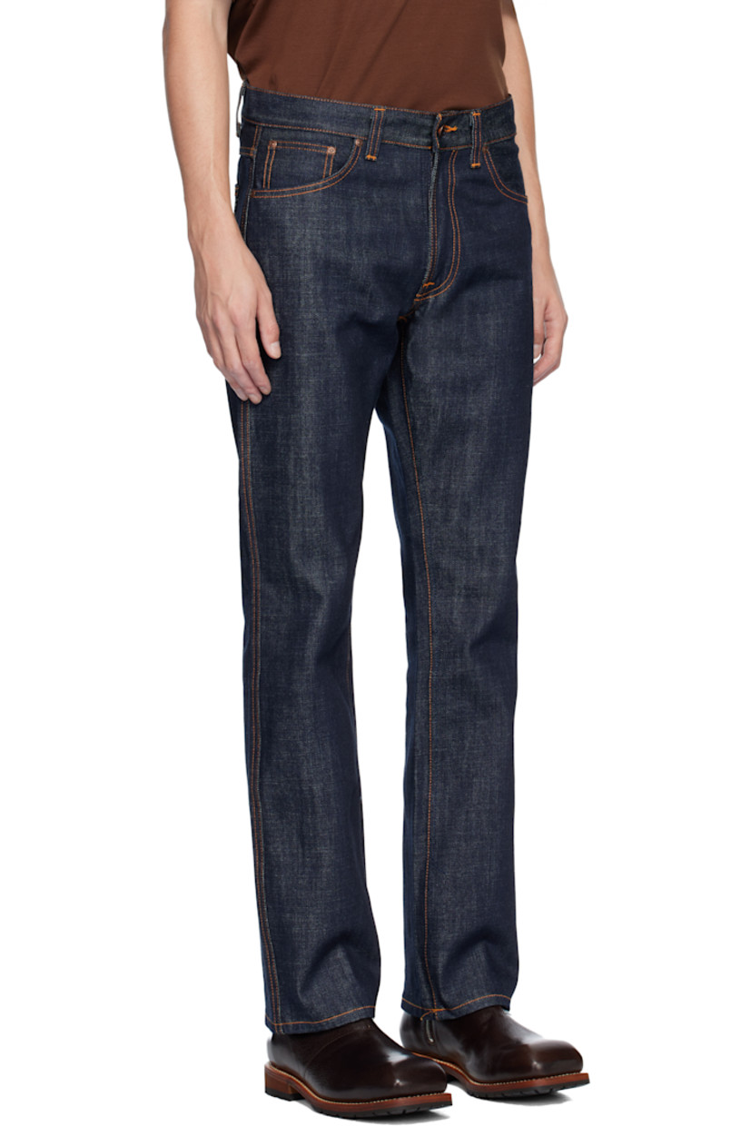 13.7 oz non-stretch organic cotton denim jeans.

· Slim-fit
· Mid-rise
· Belt loops
· Five-pocket styling
· Button fly 
· Logo patch at back waistband 
· Logo flag at back pocket
· Contrast stitching in tan 

Supplier color: Dry streaky