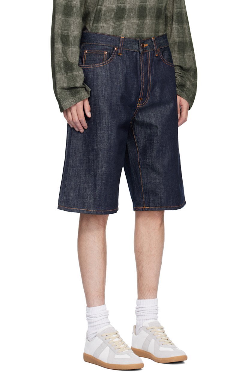 13.7 oz non-stretch organic cotton denim shorts.

· Loose-fit, wide-leg
· High-rise 
· Belt loops
· Five-pocket styling
· Button fly 
· Logo patch at back waistband 
· Logo flag at back pocket
· Contrast stitching in tan

Supplier color: Dry streaky