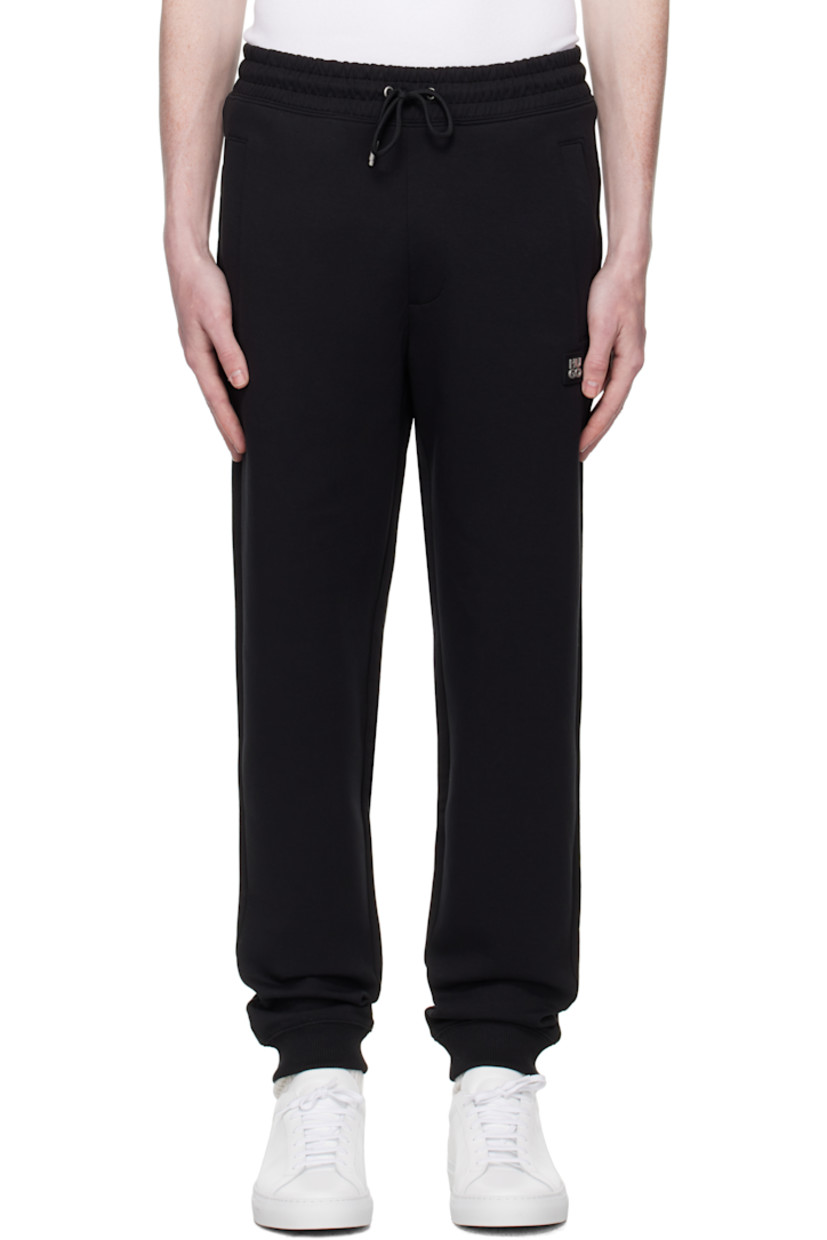 Stretch cotton jersey sweatpants.

· Drawstring at elasticized waistband
· Three-pocket styling
· Rubberized logo patch at front
· Rib-knit cuffs 

Supplier color: Black