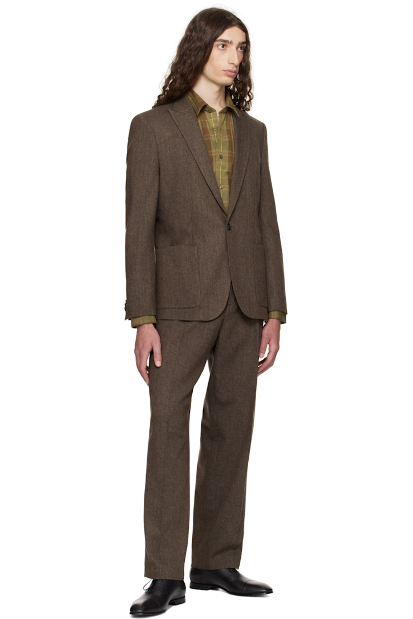 Wool- and recycled cotton-blend herringbone blazer.

· Peaked lapel
· Darts at waist
· Patch pockets at waist
· Button closure
· Twin vents at back hem
· Buttoned surgeon's cuffs
· Welt pocket at interior
· Full satin lining

Supplier color: Medium brown