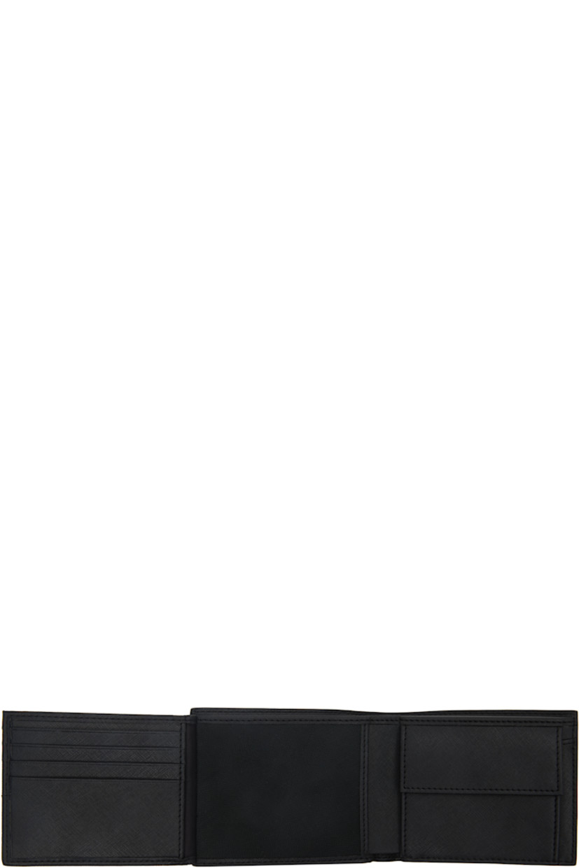 Saffiano leather trifold wallet in black. 

· Logo stamp at face
· Two patch pockets at interior 
· Mesh ID slot and eight card slots
· Coin compartment and two note slots
· Twill lining
· H3.5" x W4.5" x D1"

Supplier color: Black