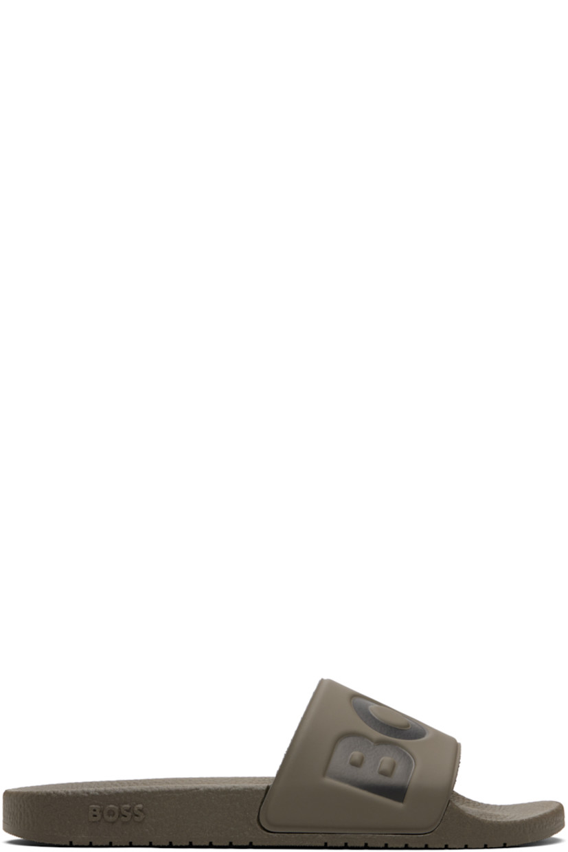 Rubber slides.

· Open toe
· Logo embossed at vamp
· Jersey lining
· Treaded rubber sole

Supplier color: Medium brown