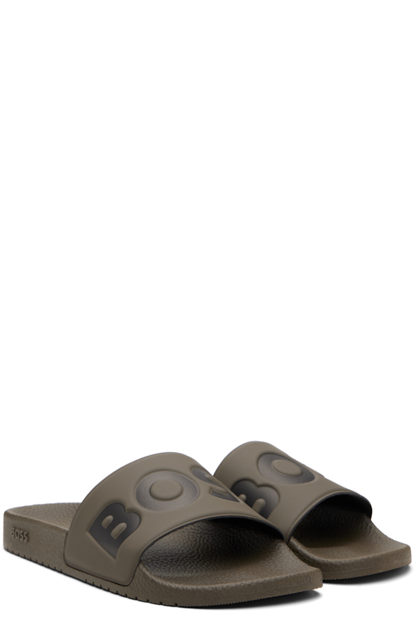 Rubber slides.

· Open toe
· Logo embossed at vamp
· Jersey lining
· Treaded rubber sole

Supplier color: Medium brown
