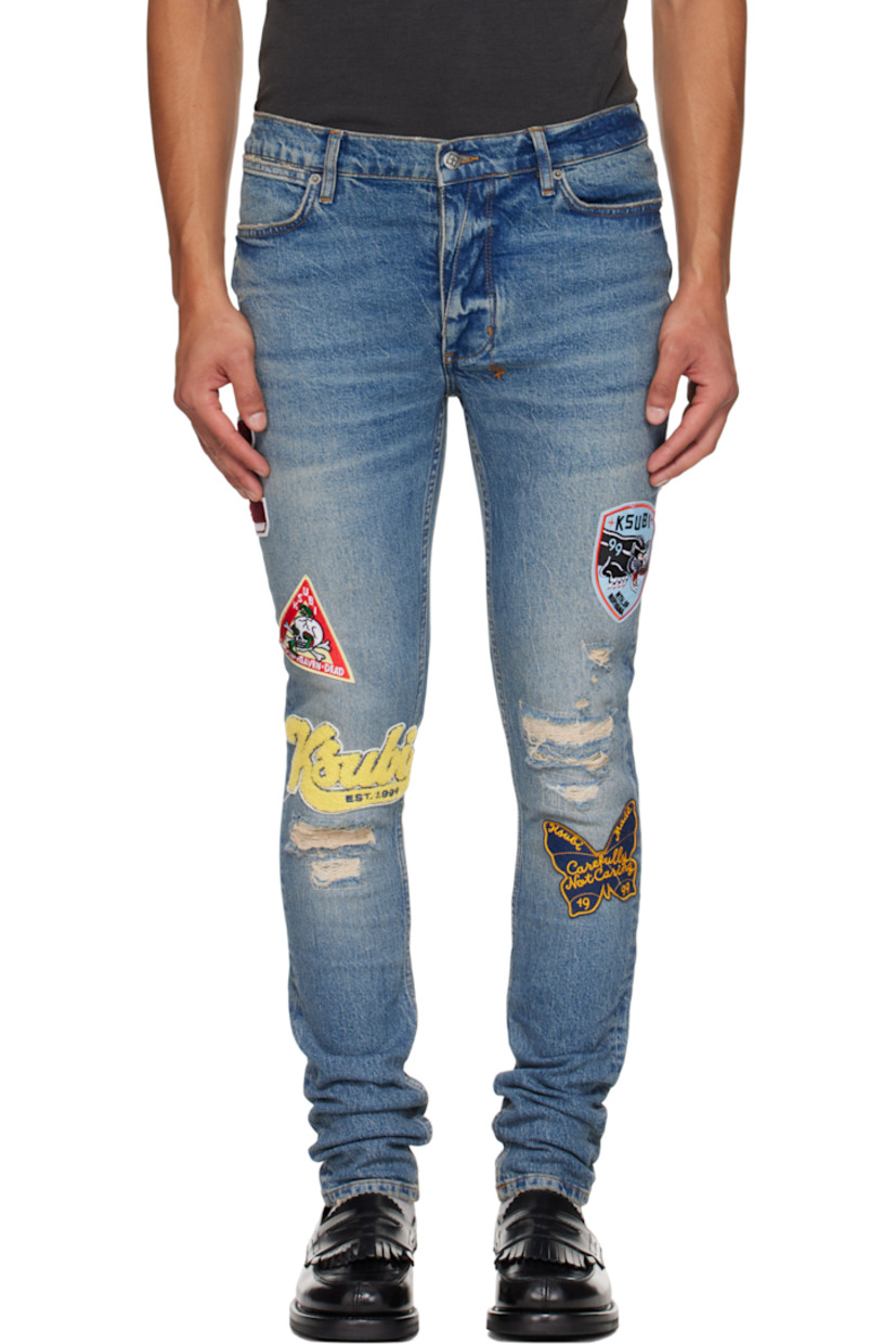 Stonewashed stretch denim jeans. 

· Skinny-fit 
· Fading, whiskering, and distressing throughout 
· Belt loops
· Five-pocket styling
· Button fly
· Graphic appliqués at legs
· Logo embroidered at back waist
· Contrast stitching in tan 

Supplier color: Denim