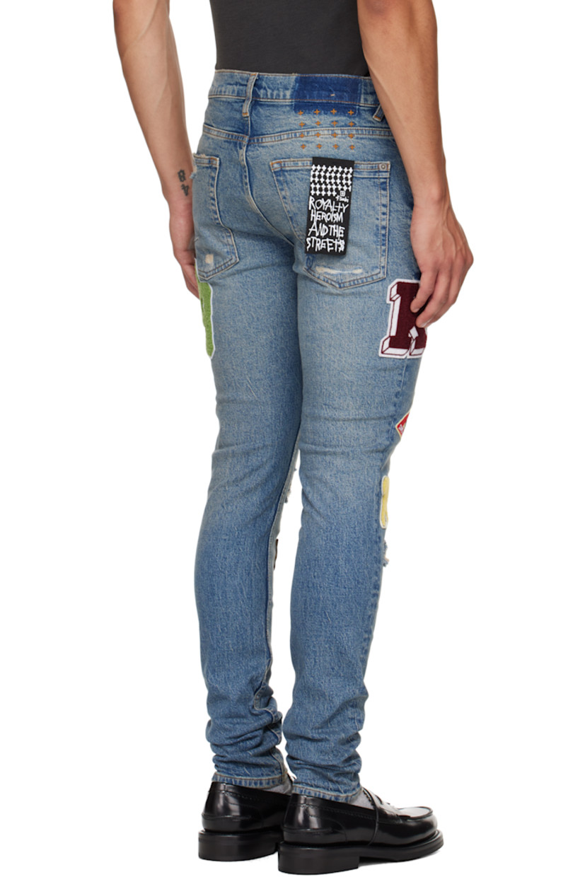 Stonewashed stretch denim jeans. 

· Skinny-fit 
· Fading, whiskering, and distressing throughout 
· Belt loops
· Five-pocket styling
· Button fly
· Graphic appliqués at legs
· Logo embroidered at back waist
· Contrast stitching in tan 

Supplier color: Denim