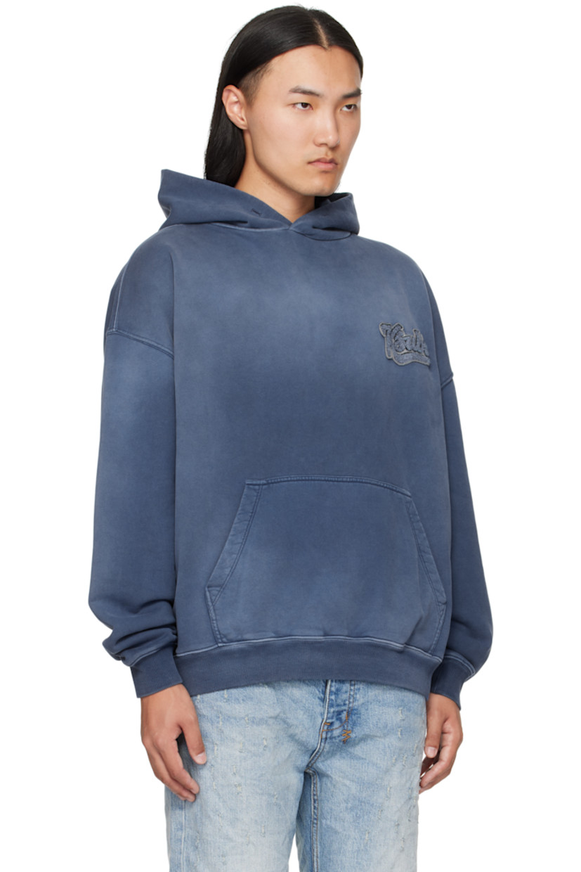 Heavyweight cotton French terry hoodie.

· Fading throughout
· Chenille logo patch at chest
· Kangaroo pocket at waist
· Rib-knit hem and cuffs
· Embroidered logo and text patches at back
· Embroidered logos at back hem

Supplier color: Ink blue