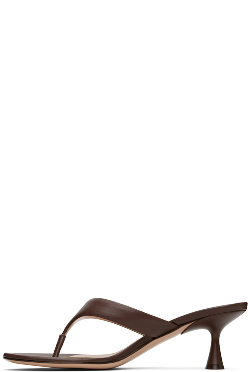 Handcrafted buffed nappa leather heeled sandals in brown. 

· Open toe
· Thong-style strap with logo hardware at vamp
· Logo stamp at leather footbed
· Covered spool heel with rubber injection
· Polished leather sole
· Heel: H2.5"

Supplier color: Nappa brown