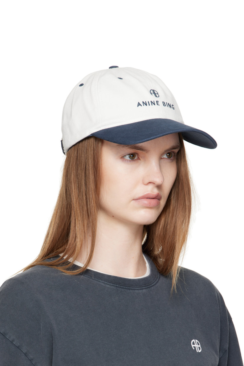 Handcrafted cotton twill cap.

· Embroidered eyelets at crown
· Logo embroidered at face and back
· Curved brim
· Cinch fastening

Supplier color: Ivory/Navy
