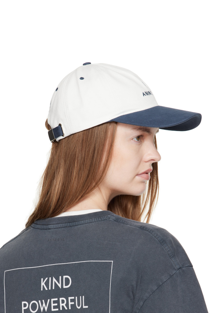 Handcrafted cotton twill cap.

· Embroidered eyelets at crown
· Logo embroidered at face and back
· Curved brim
· Cinch fastening

Supplier color: Ivory/Navy