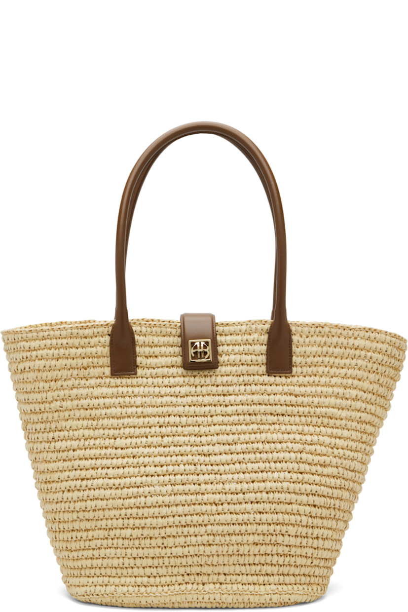 Handcrafted woven cellulose tote.

· Buffed leather trim throughout
· Fixed twin rolled shoulder straps
· Logo hardware at magnetic press-stud tab closure 
· Unlined
· Gold-tone hardware
· H12.5" x W19.5" x D4.5"

Supplier color: Natural/Cognac
