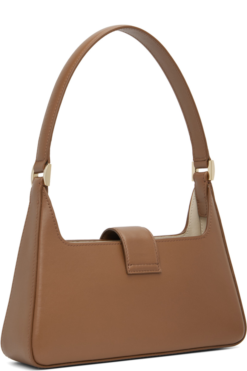 Buffed leather shoulder bag.

· Fixed shoulder strap
· Logo hardware at face
· Magnetic foldover flap
· Patch pocket at interior
· Gold-tone hardware
· H5” x W10” x D2.5”

Supplier color: Cognac