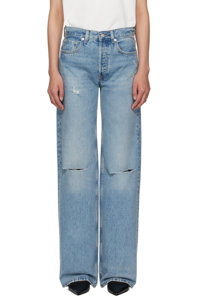 Wide-leg non-stretch denim jeans.

· Fading, whiskering, and distressing throughout
· Mid-rise
· Belt loops
· Five-pocket styling
· Button fly
· Logo patch at back waistband
· Logo engraved silver-tone hardware

Supplier color: Summer Indigo Destructed