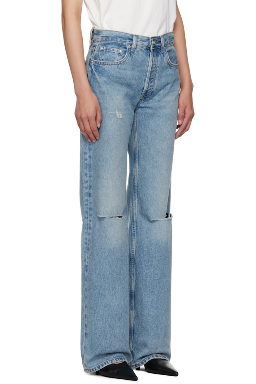 Wide-leg non-stretch denim jeans.

· Fading, whiskering, and distressing throughout
· Mid-rise
· Belt loops
· Five-pocket styling
· Button fly
· Logo patch at back waistband
· Logo engraved silver-tone hardware

Supplier color: Summer Indigo Destructed