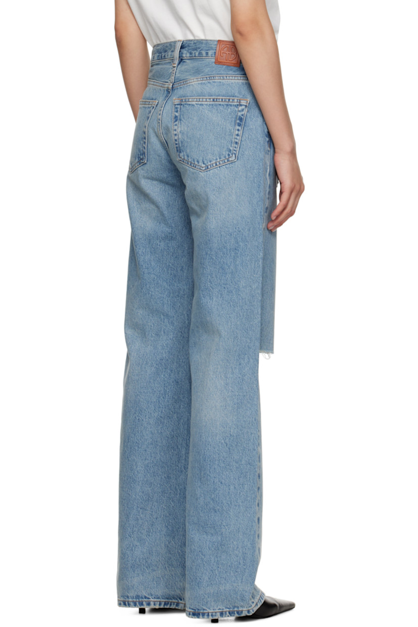 Wide-leg non-stretch denim jeans.

· Fading, whiskering, and distressing throughout
· Mid-rise
· Belt loops
· Five-pocket styling
· Button fly
· Logo patch at back waistband
· Logo engraved silver-tone hardware

Supplier color: Summer Indigo Destructed