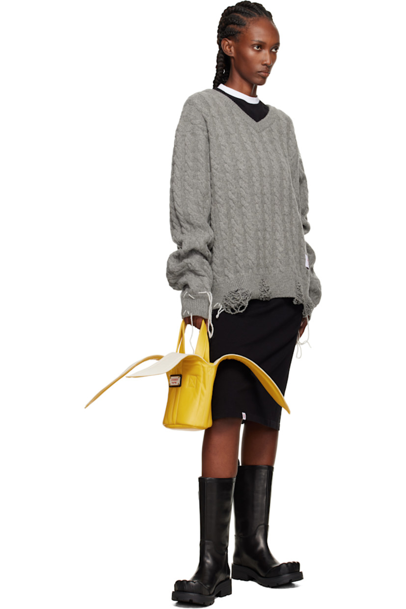 Buffed leather shoulder bag.

· Fixed carry handles
· Adjustable and detachable crossbody strap
· Graphic appliqués at top
· Logo plaque at face
· H7.5" x W9" x D4.5"

Supplier color: Yellow/Ecru