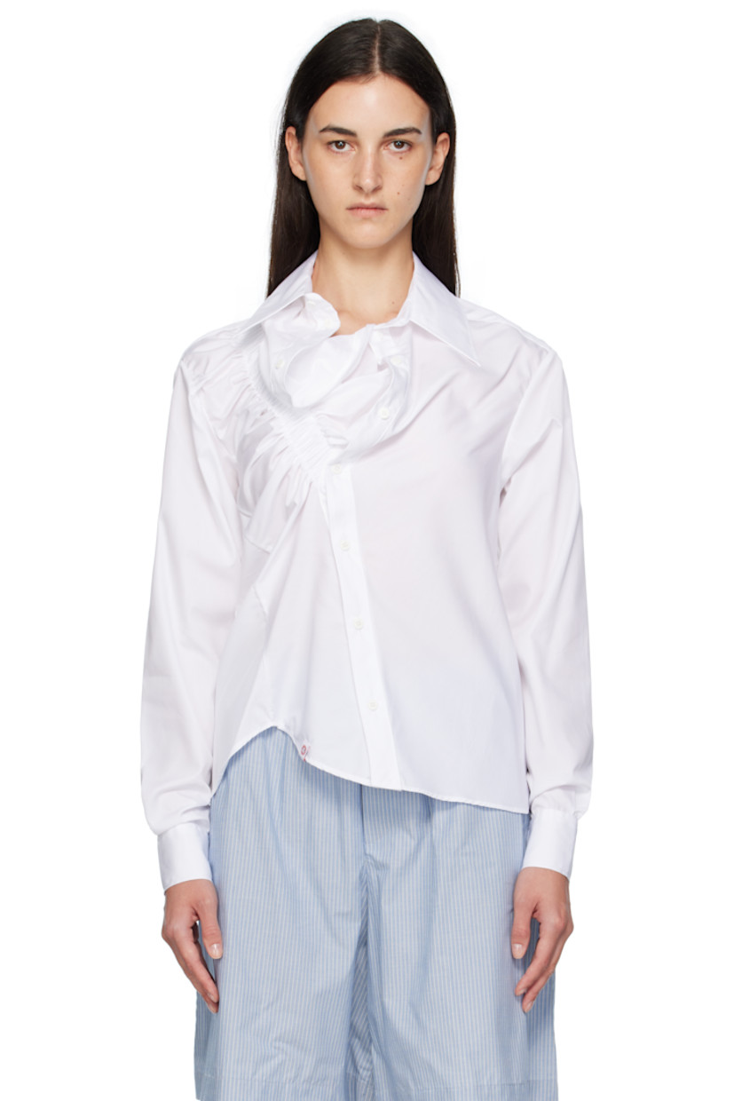 Cotton poplin shirt.

· Asymmetrical construction
· Spread collar
· Button closure
· Elasticized trim at front
· Logo flag at front hem
· Shirttail hem
· Buttoned barrel cuffs
· Box pleat at back yoke

Supplier color: White