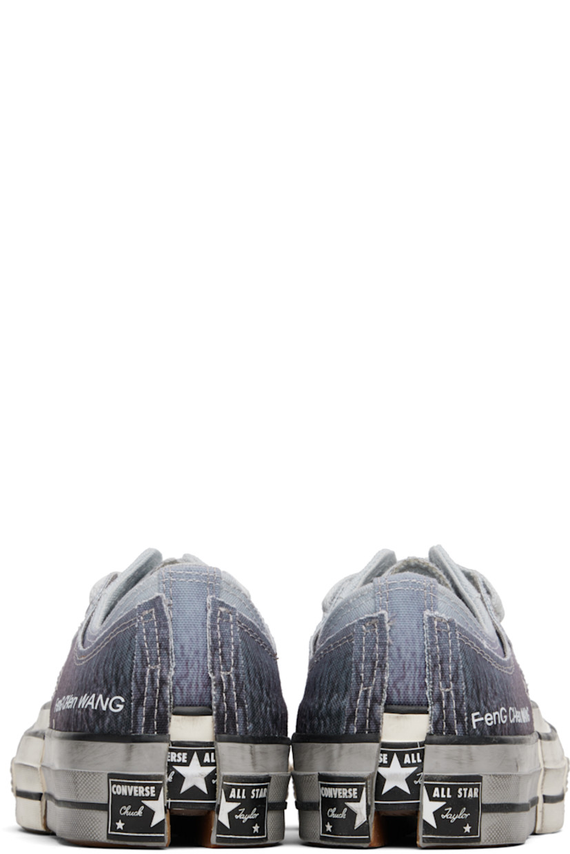 Low-top canvas sneakers. Smudging, graphic patterns, and raw edges throughout.

· Rubber cap toe
· Lace-up closure
· Logo printed at outer side
· Metal eyelet at inner side
· Modified notched rubber sole
· Includes alternate laces in gray

Part of the Feng Chen Wang x Converse collaboration.

Supplier color: Blue/Egret/Black