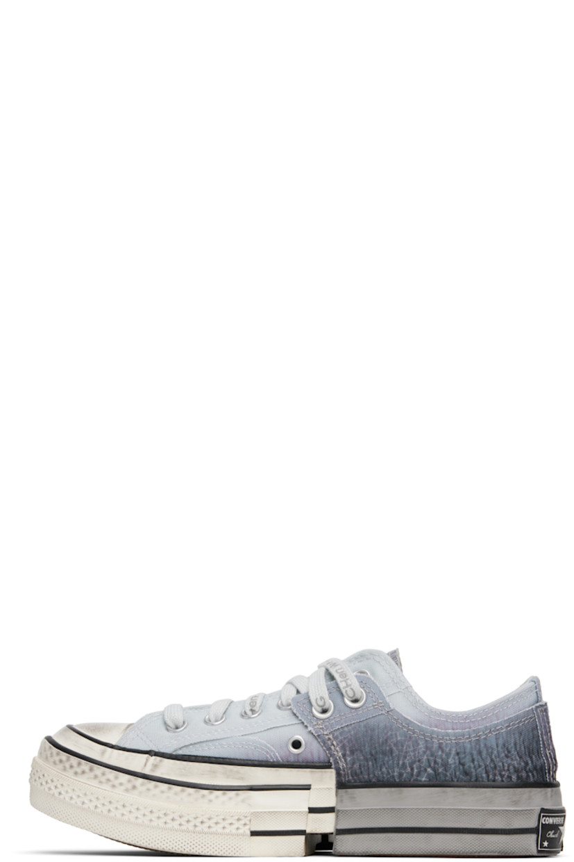 Low-top canvas sneakers. Smudging, graphic patterns, and raw edges throughout.

· Rubber cap toe
· Lace-up closure
· Logo printed at outer side
· Metal eyelet at inner side
· Modified notched rubber sole
· Includes alternate laces in gray

Part of the Feng Chen Wang x Converse collaboration.

Supplier color: Blue/Egret/Black