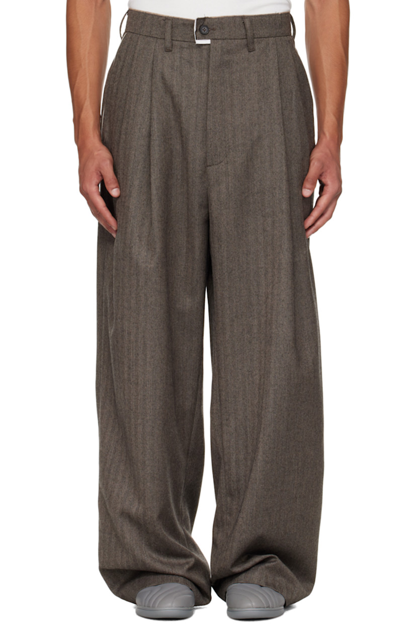 Virgin wool herringbone trousers.

· Wide straight-leg
· Raw edge at waistband
· Belt loops
· Three-pocket styling
· Zip fly
· Pleats at waist
· Dropped inseam
· Horn hardware

Supplier color: Herringbone