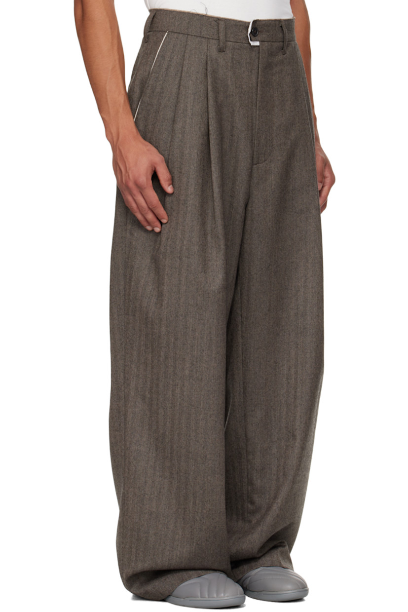 Virgin wool herringbone trousers.

· Wide straight-leg
· Raw edge at waistband
· Belt loops
· Three-pocket styling
· Zip fly
· Pleats at waist
· Dropped inseam
· Horn hardware

Supplier color: Herringbone
