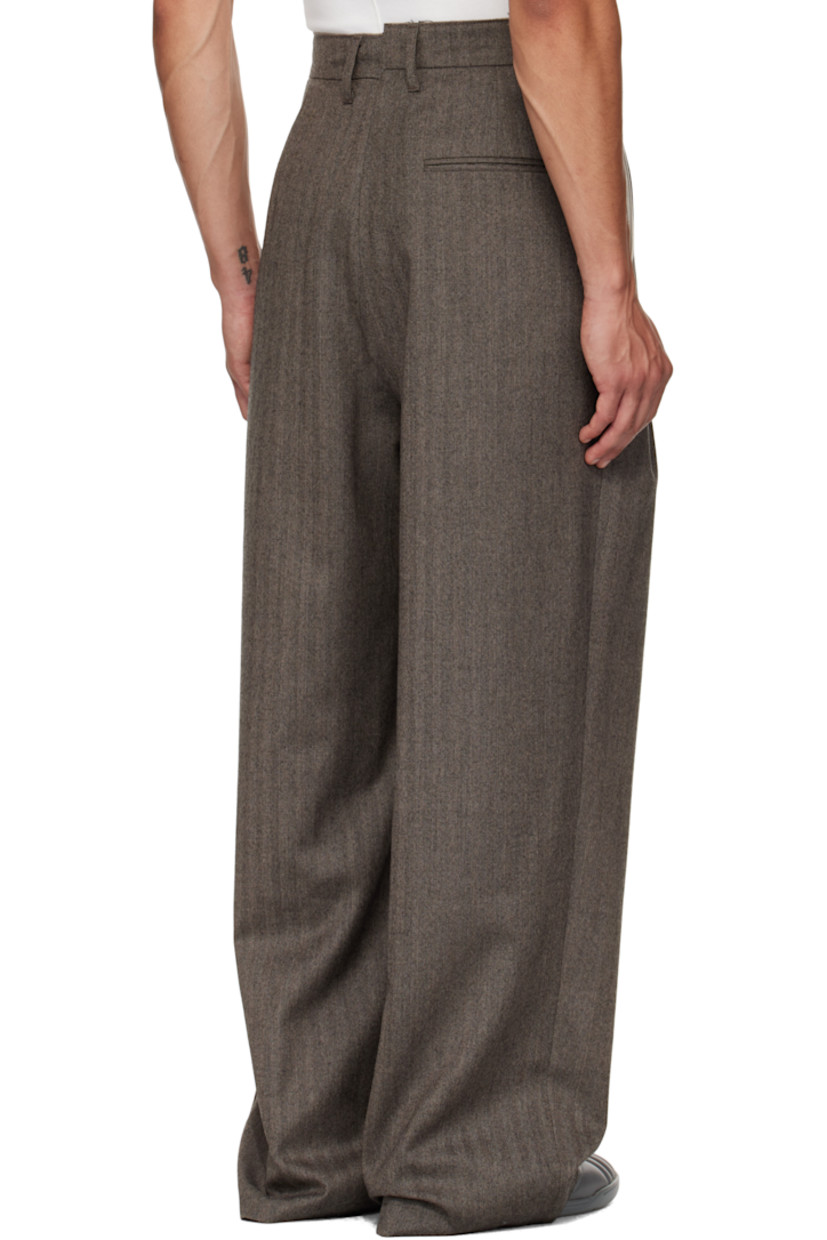 Virgin wool herringbone trousers.

· Wide straight-leg
· Raw edge at waistband
· Belt loops
· Three-pocket styling
· Zip fly
· Pleats at waist
· Dropped inseam
· Horn hardware

Supplier color: Herringbone