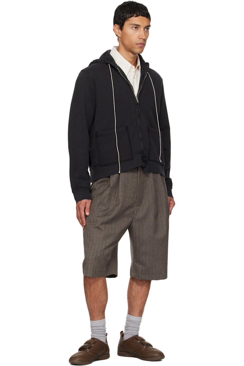 French terry hoodie. 

· Exposed seams and fading throughout 
· Drawstring at hood
· Zip closure
· Patch pockets at waist
· Rib-knit hem and cuffs

Supplier color: Black