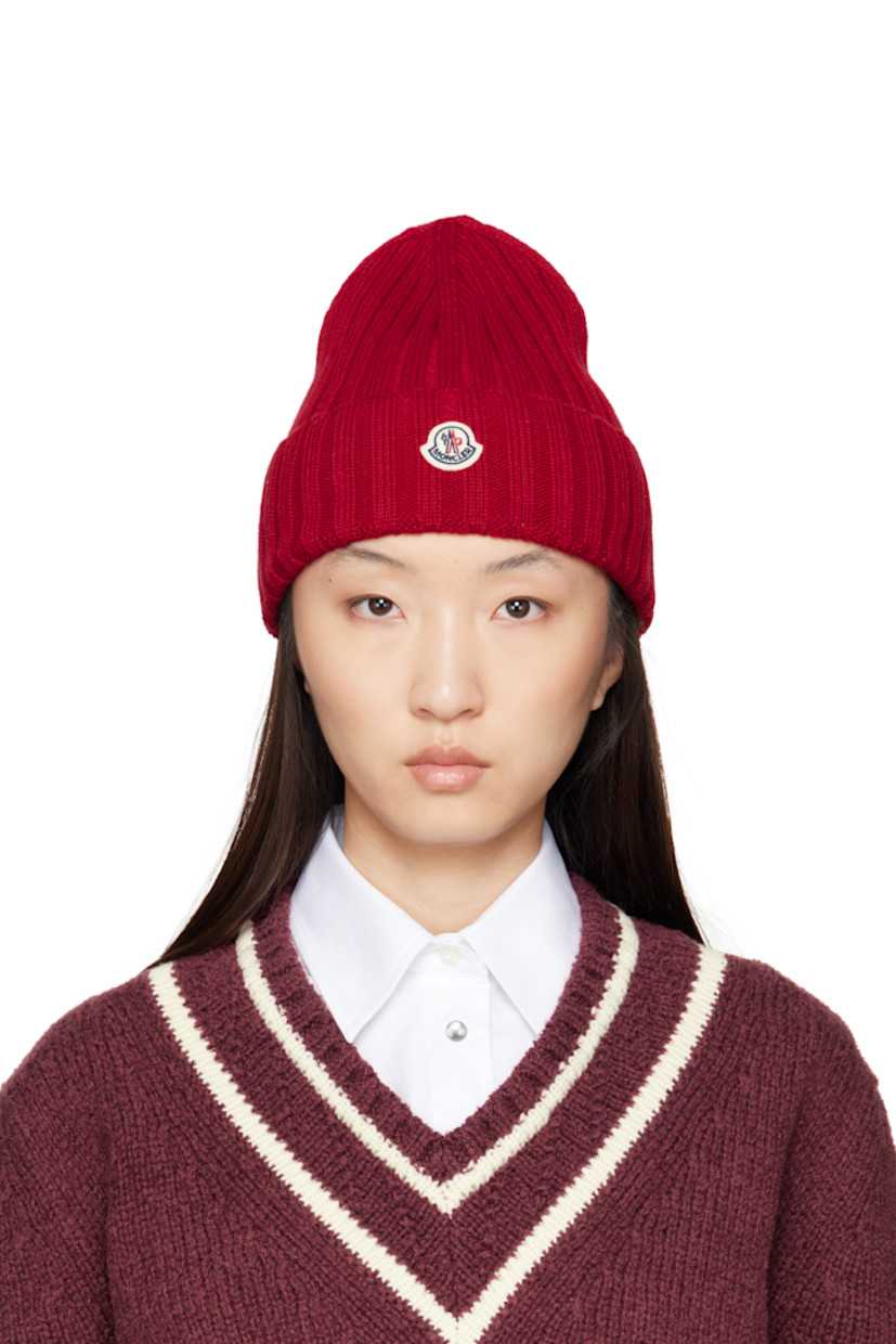 Rib-knit virgin wool beanie. Felted logo patch at rolled brim.

Supplier color: Fire red