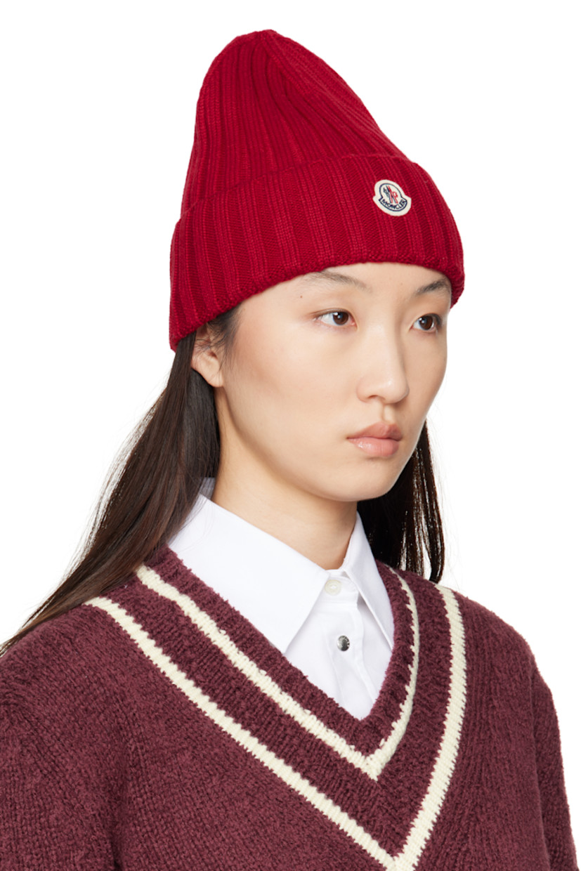 Rib-knit virgin wool beanie. Felted logo patch at rolled brim.

Supplier color: Fire red