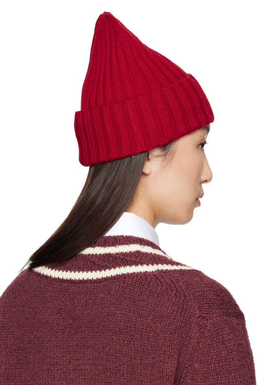 Rib-knit virgin wool beanie. Felted logo patch at rolled brim.

Supplier color: Fire red