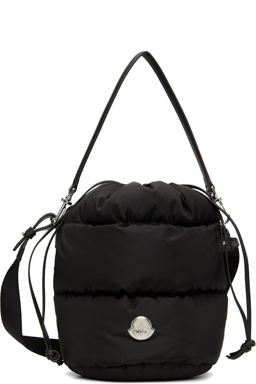 Down-filled and quilted nylon taffeta shoulder bag.

· Water-repellent
· DIST-certified down
· Detachable calfskin carry handle
· Detachable crossbody strap
· Logo hardware at face
· Drawstring closure
· Patch pocket at interior
· H9.5" x W9" x D6.5"

Supplier color: Black

Fill: 90% goose down, 10% goose feather.