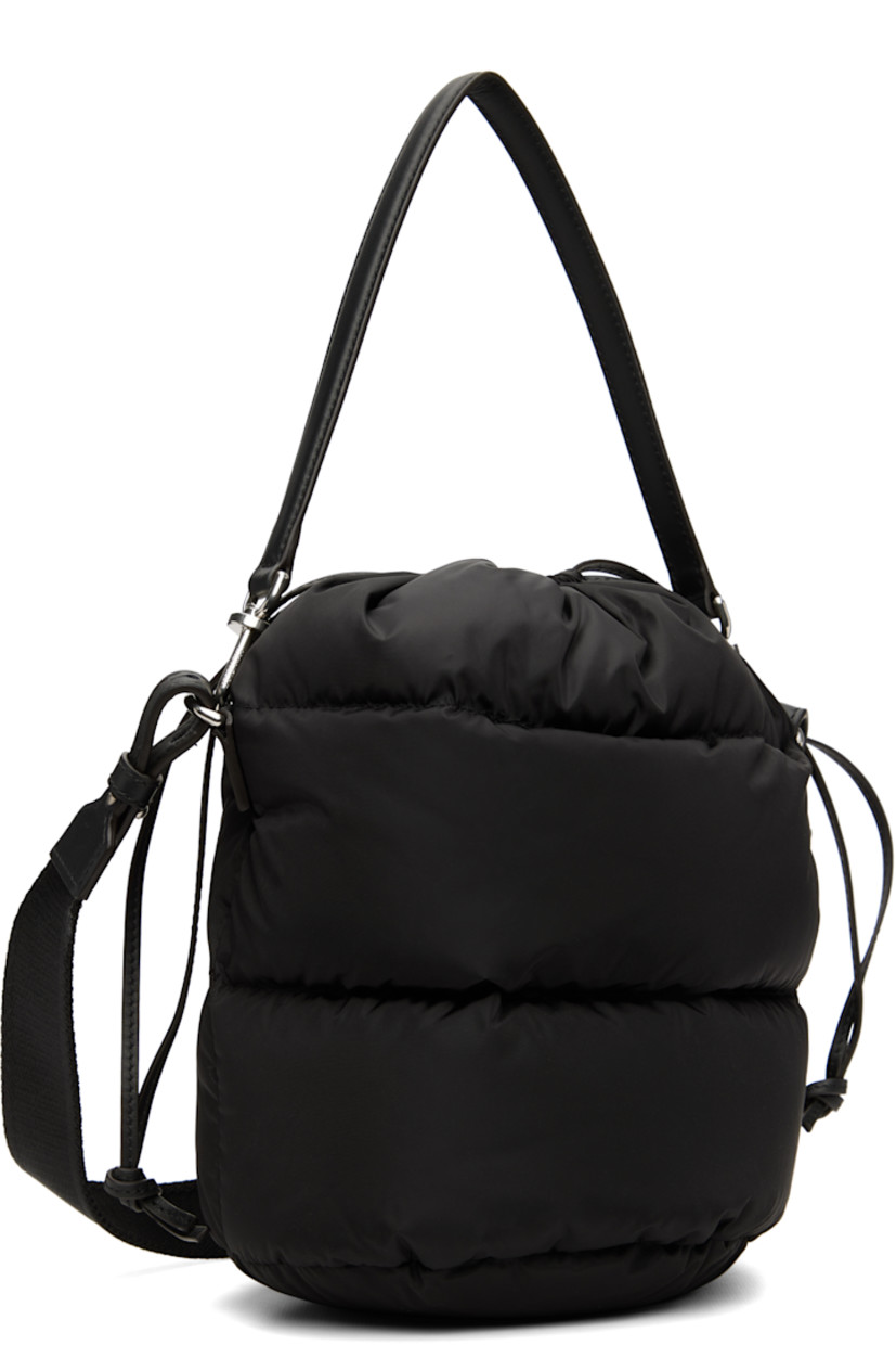 Down-filled and quilted nylon taffeta shoulder bag.

· Water-repellent
· DIST-certified down
· Detachable calfskin carry handle
· Detachable crossbody strap
· Logo hardware at face
· Drawstring closure
· Patch pocket at interior
· H9.5" x W9" x D6.5"

Supplier color: Black

Fill: 90% goose down, 10% goose feather.
